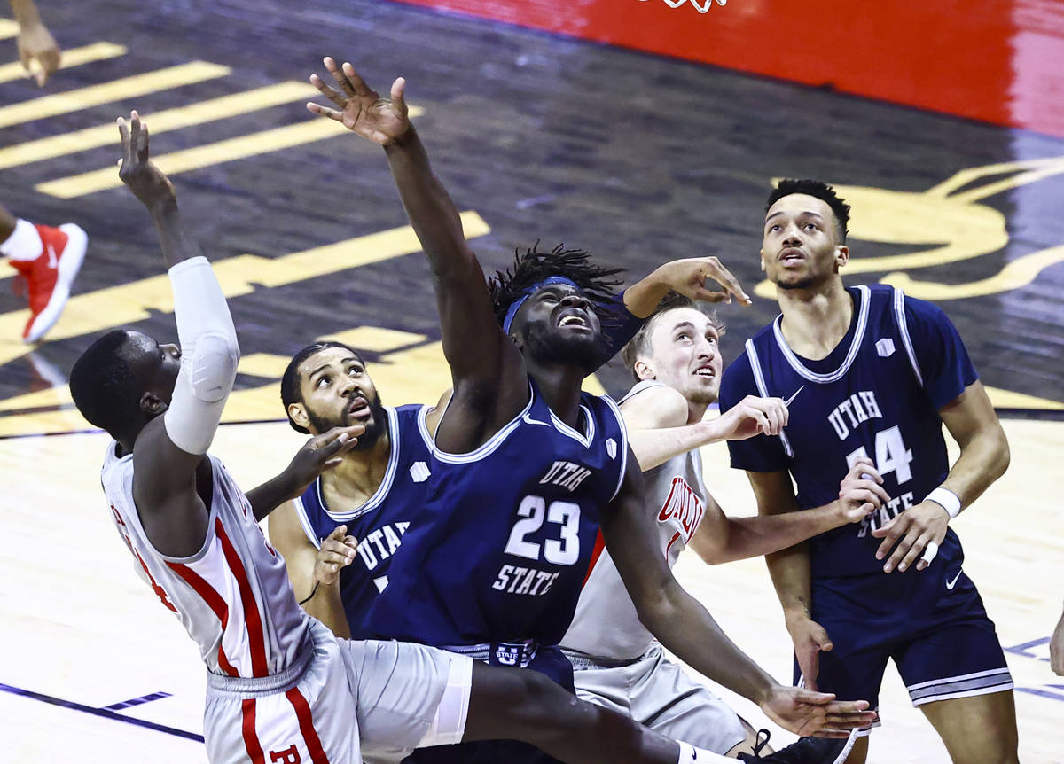 Utah State Aggies center Neemias Queta (23) and UNLV Rebels forward Moses Wood (1) battle for a ...