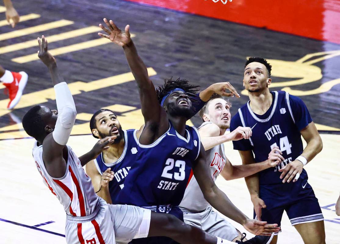 Utah State Aggies center Neemias Queta (23) and UNLV Rebels forward Moses Wood (1) battle for a ...