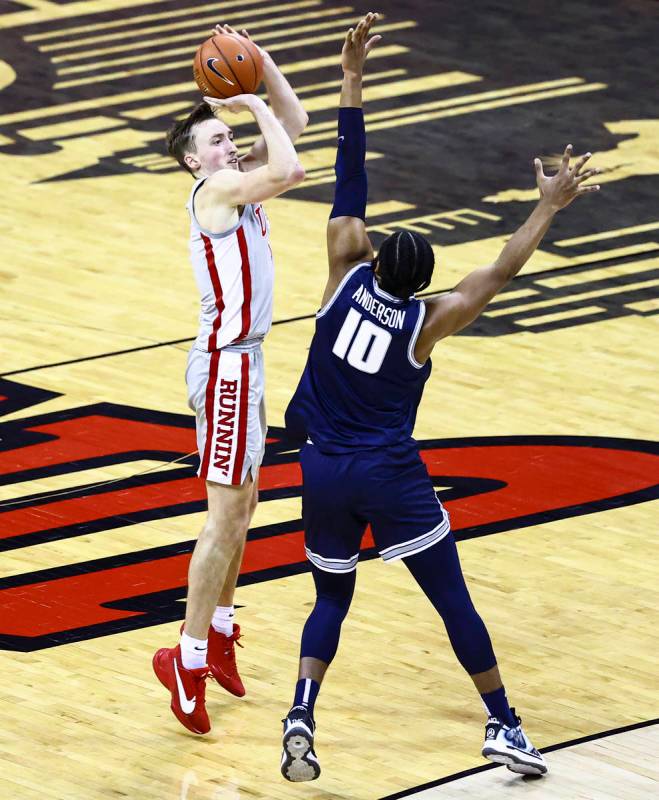 UNLV Rebels forward Moses Wood (1) shoots over Utah State Aggies forward Alphonso Anderson (10) ...