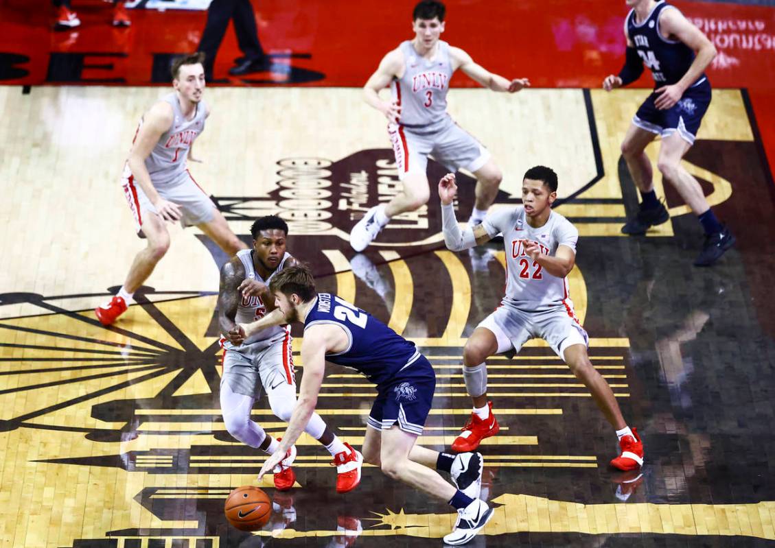 Utah State Aggies guard Rollie Worster (24) drives to the basket against UNLV Rebels guards Dav ...