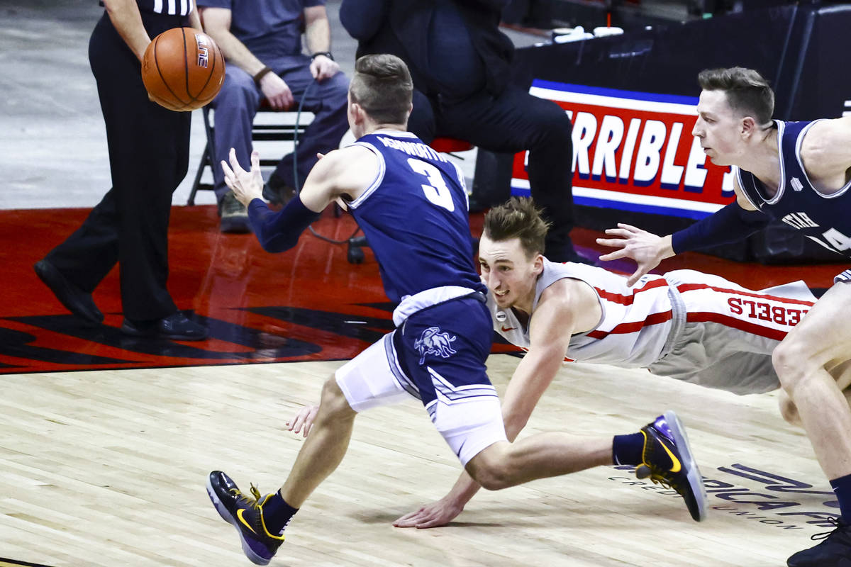 UNLV Rebels forward Moses Wood (1) dives for a rebound against Utah State Aggies guard Steven A ...