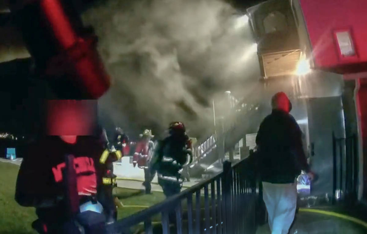 This frame grab from video provided by the New London Police Department shows firefighters res ...