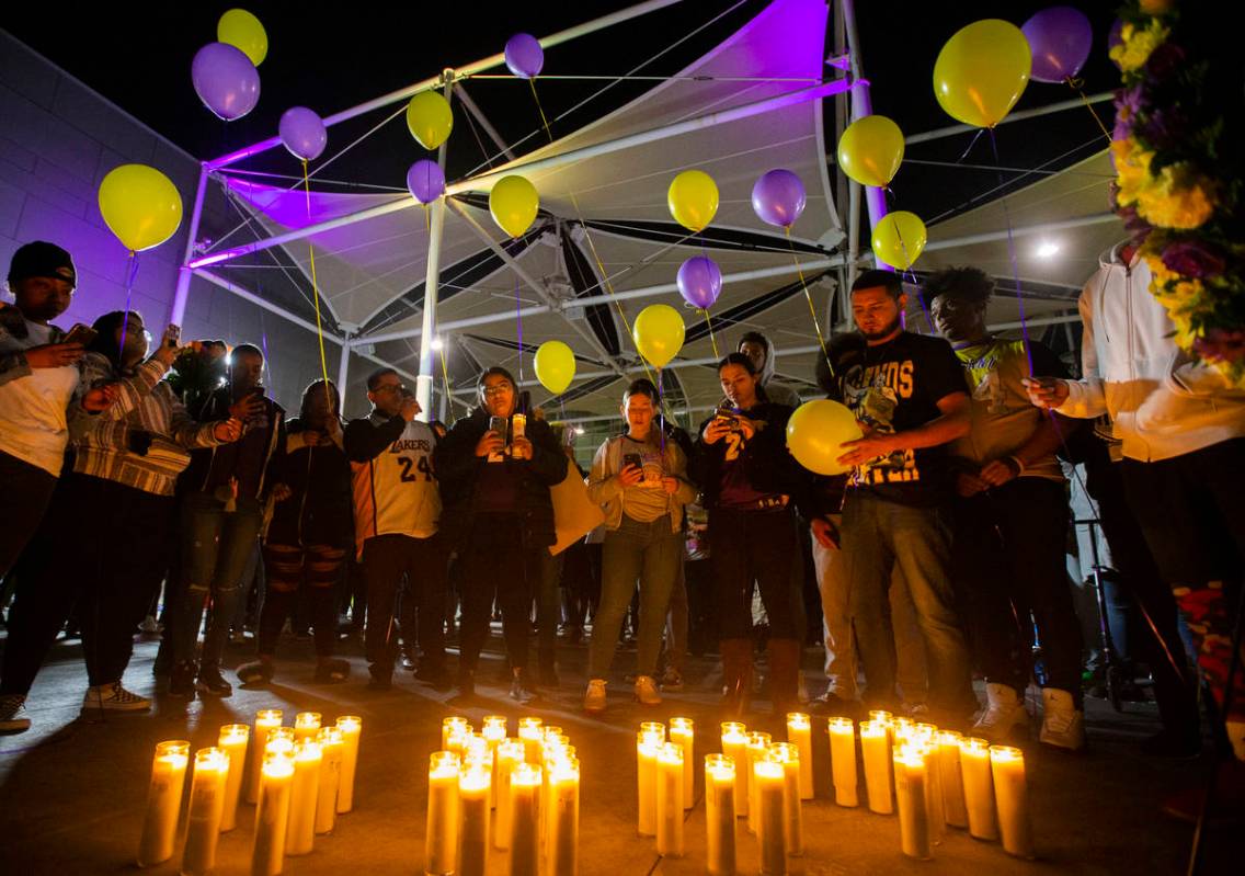 Fans get ready to release balloons with Los Angeles Laker colors during a vigil for Kobe Bryant ...