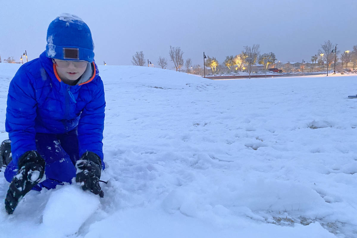 Justin Buzoff, 13, builds a snowman at Fox Hills Park on the far west side of the Las Vegas Val ...