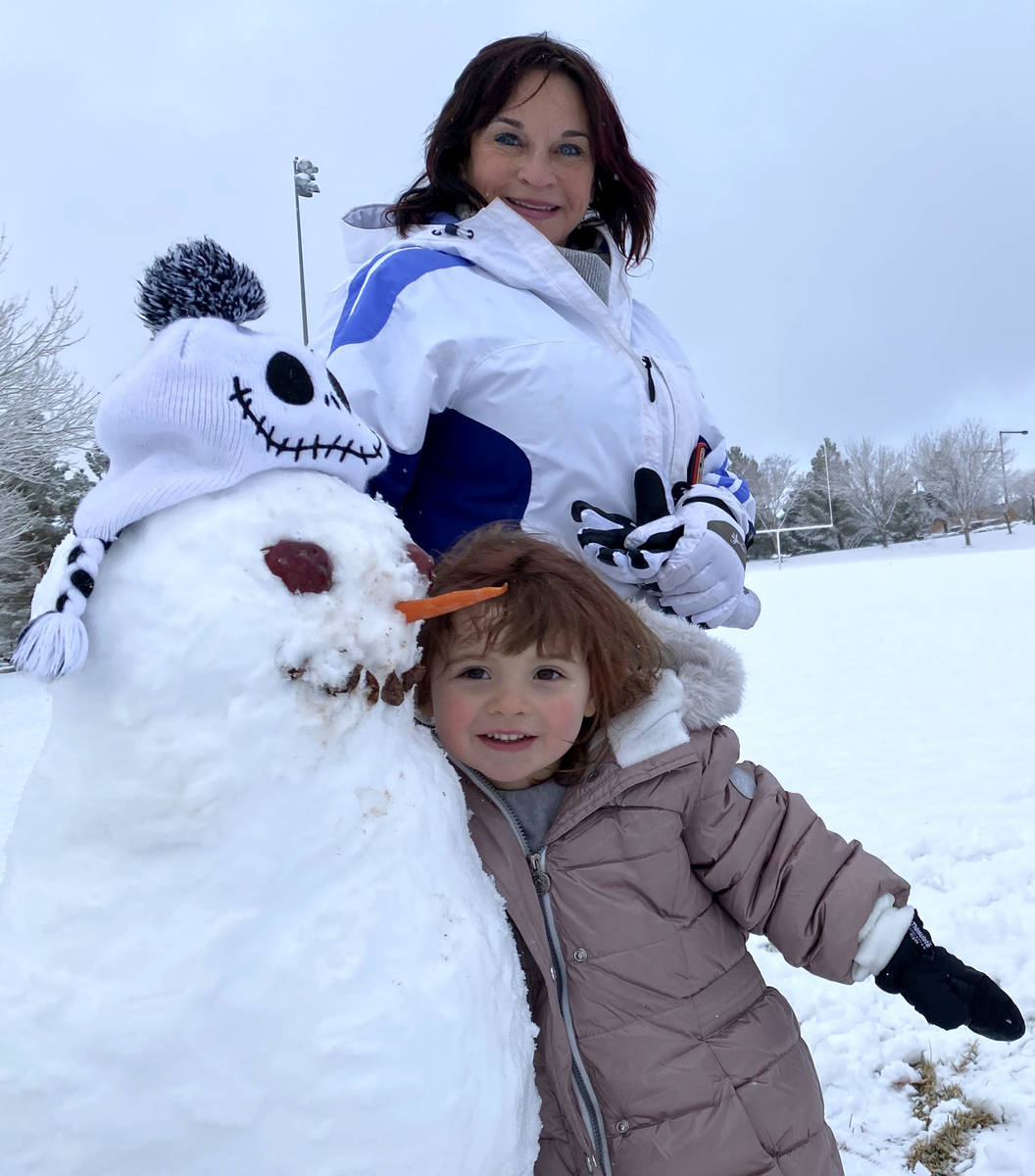 Rylie OՂrien, 3, and her grandmother Lisa Hauger pose for a photo with a snowman after ma ...