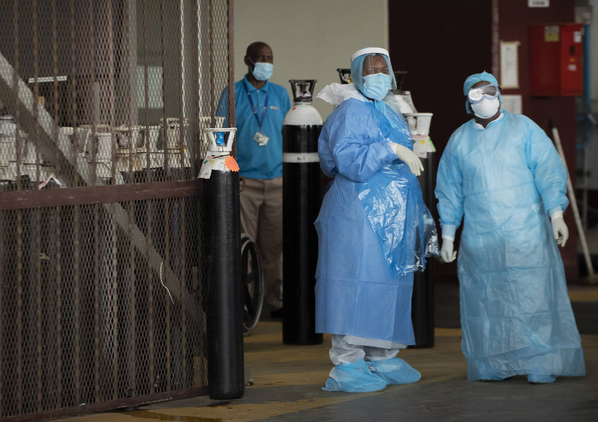 Health workers in protective suits in a makeshift emergency unit at Steve Biko Academic Hospita ...