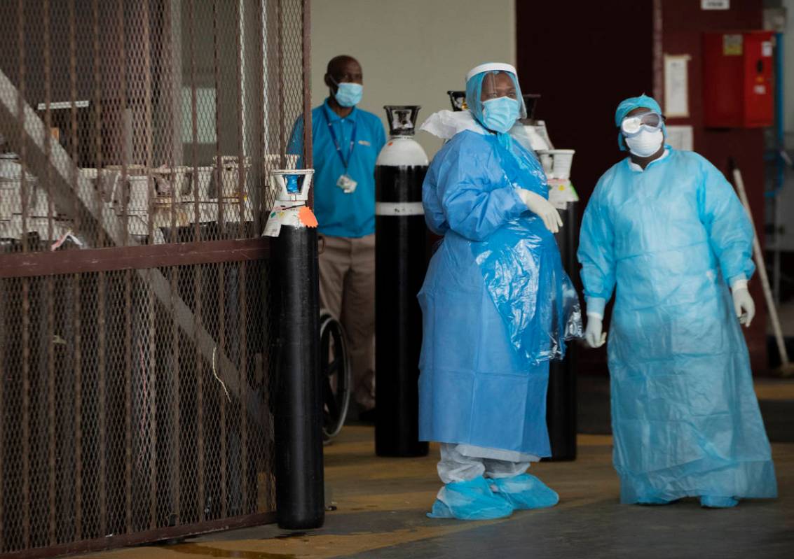 Health workers in protective suits in a makeshift emergency unit at Steve Biko Academic Hospita ...