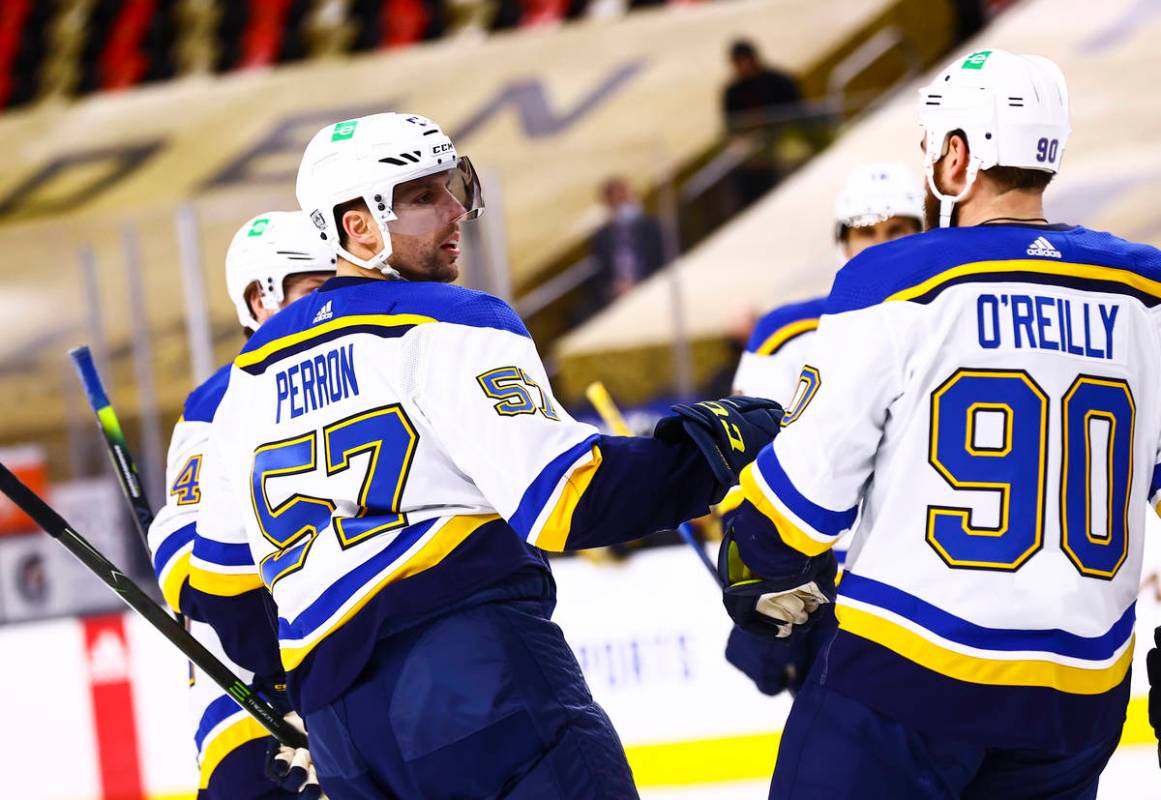 St. Louis Blues left wing David Perron (57) celebrates with his team after scoring against the ...