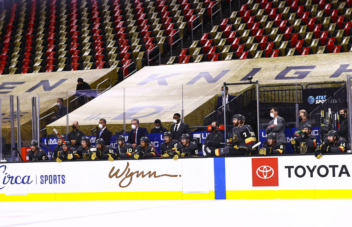 Empty seats are seen behind the Golden Knights bench during the first period of an NHL hockey g ...