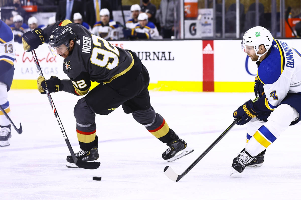 Golden Knights left wing Tomas Nosek (92) moves the puck around St. Louis Blues defenseman Carl ...