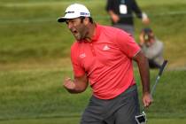 Jon Rahm reacts after making his putt on the first playoff hole during the final round of the B ...