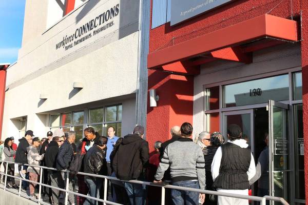 People wait in line at One-Stop Career Center in Las Vegas in this March 16, 2020, file photo. ...