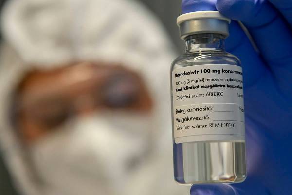 A bottle containing the drug Remdesivir is held by a health worker in Debrecen, Hungary. (Zsolt ...