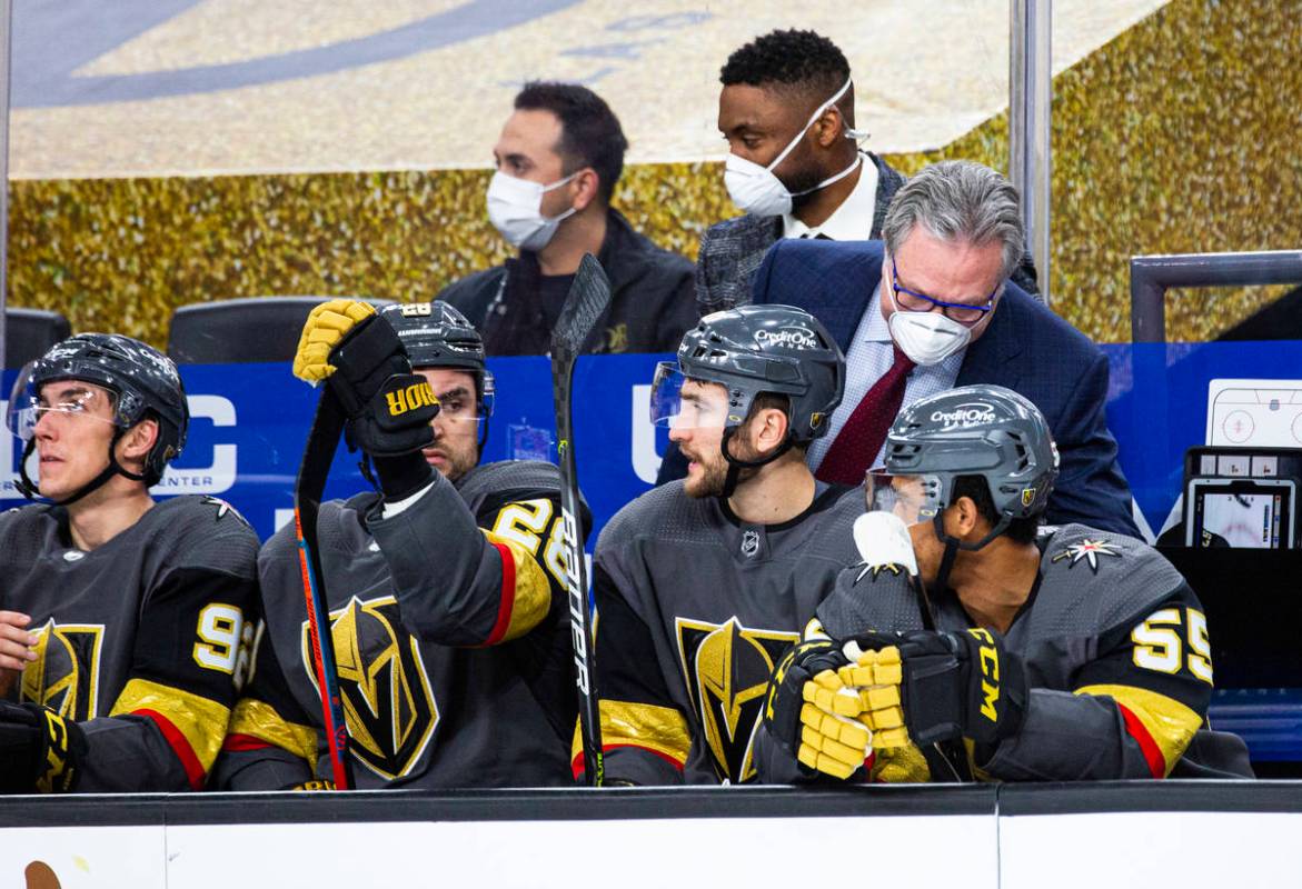 Golden Knights general manager Kelly McCrimmon, helping fill in on coaching duty, talks with pl ...