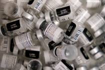 In a Friday, Jan. 22, 2021, file photo, empty vials of the Pfizer-BioNTech COVID-19 vaccine are ...
