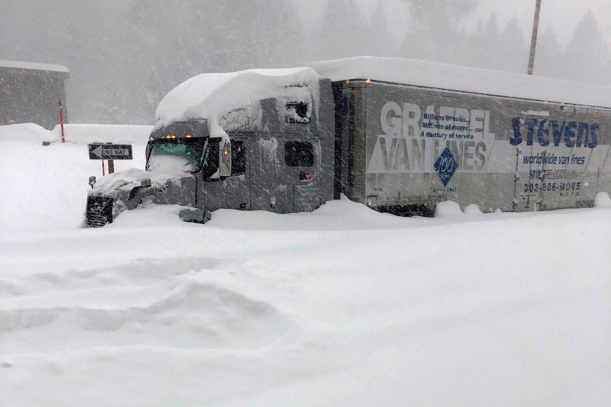 A tractor trailer is stuck in heavy snowfall at Crestview along U.S. Hwy 395, closed in Mono Co ...