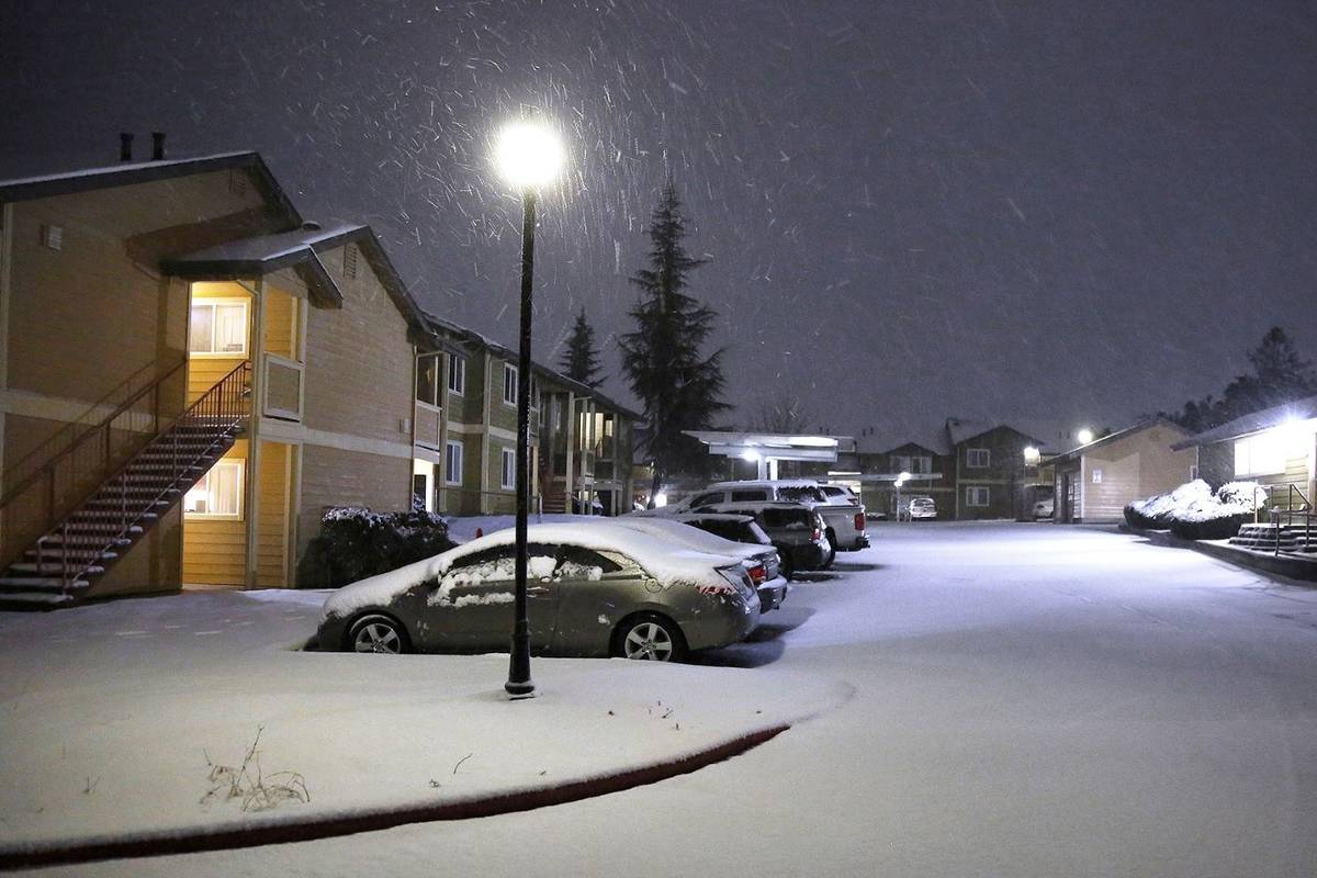 Snow accumulates at the Cedar Park Apartments in Grass Valley, Calif., Tuesday evening, Jan 26, ...