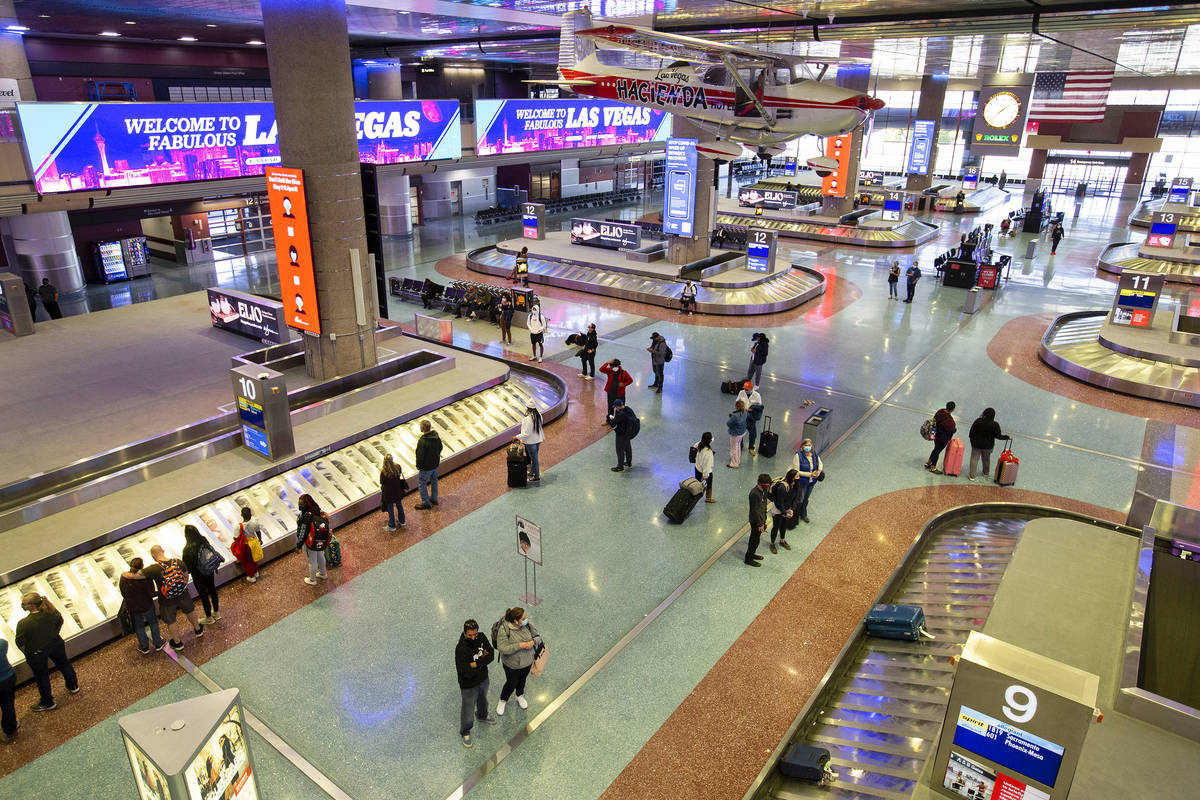 Visitors wait for their luggage at McCarran International Airport ahead of the Thanksgiving hol ...