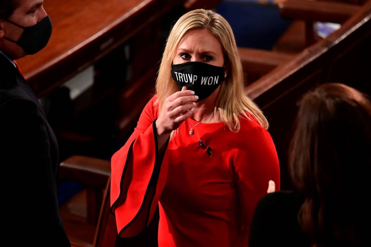 Rep. Marjorie Taylor Greene, R-Ga., wears a "Trump Won" face mask as she arrives on the floor o ...