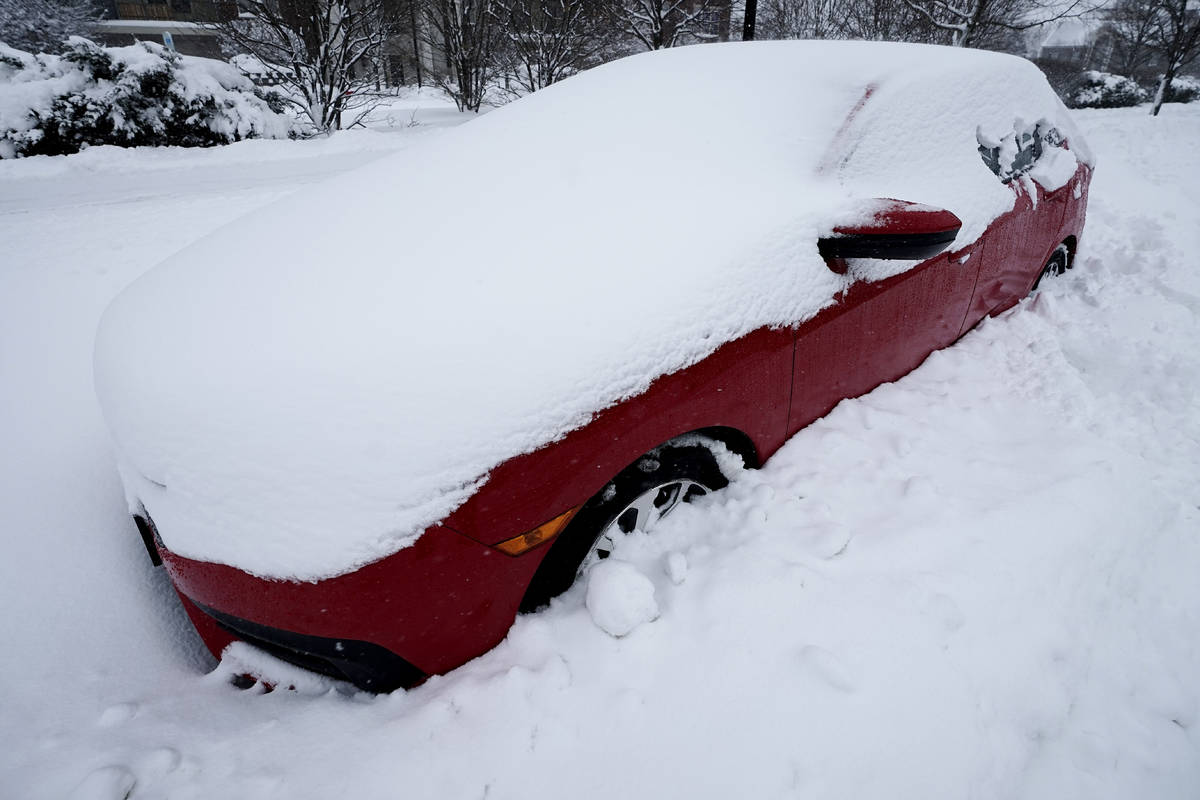 A car is covered by snow in Wheeling, Ill., Sunday, Jan. 31, 2021. Winter storm may leave more ...