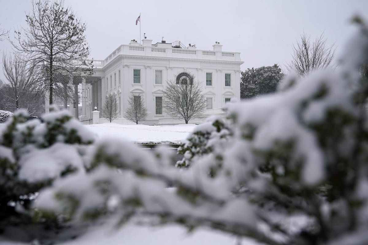 Snow falls on the North Lawn of the White House, Sunday, Jan. 31, 2021, in Washington. (AP Phot ...