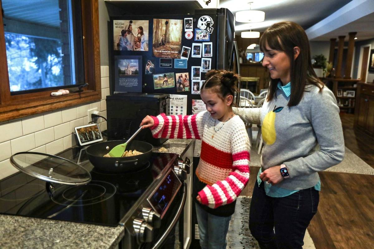 Missy Millard, left, cooks with her mom, Kim, in their home in Layton on Thursday, Jan. 28, 202 ...
