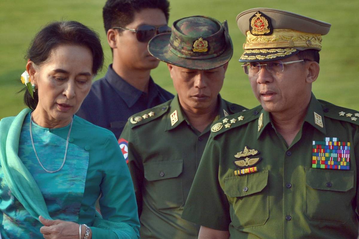 Aung San Suu Kyi, left, Myanmar's foreign minister, walks with senior General Min Aung Hlaing, ...