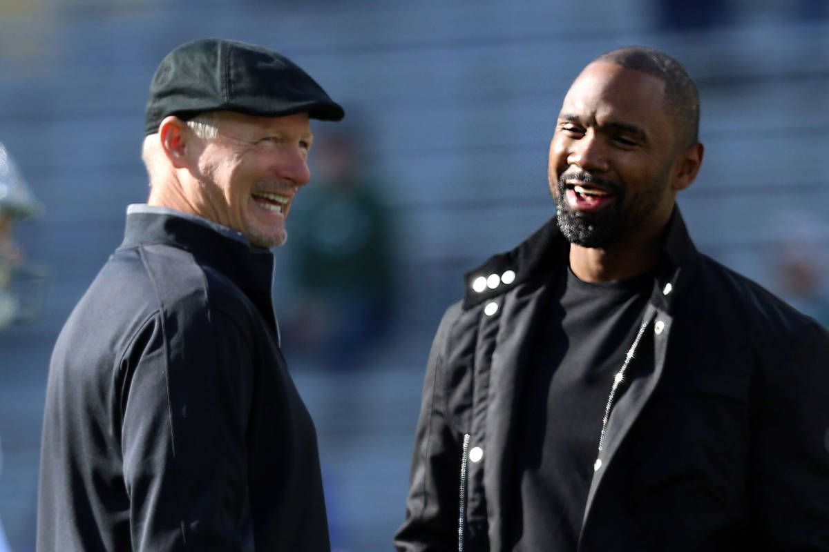 Oakland Raiders general manager Mike Mayock, left, speaks with former Raiders and Packers corne ...