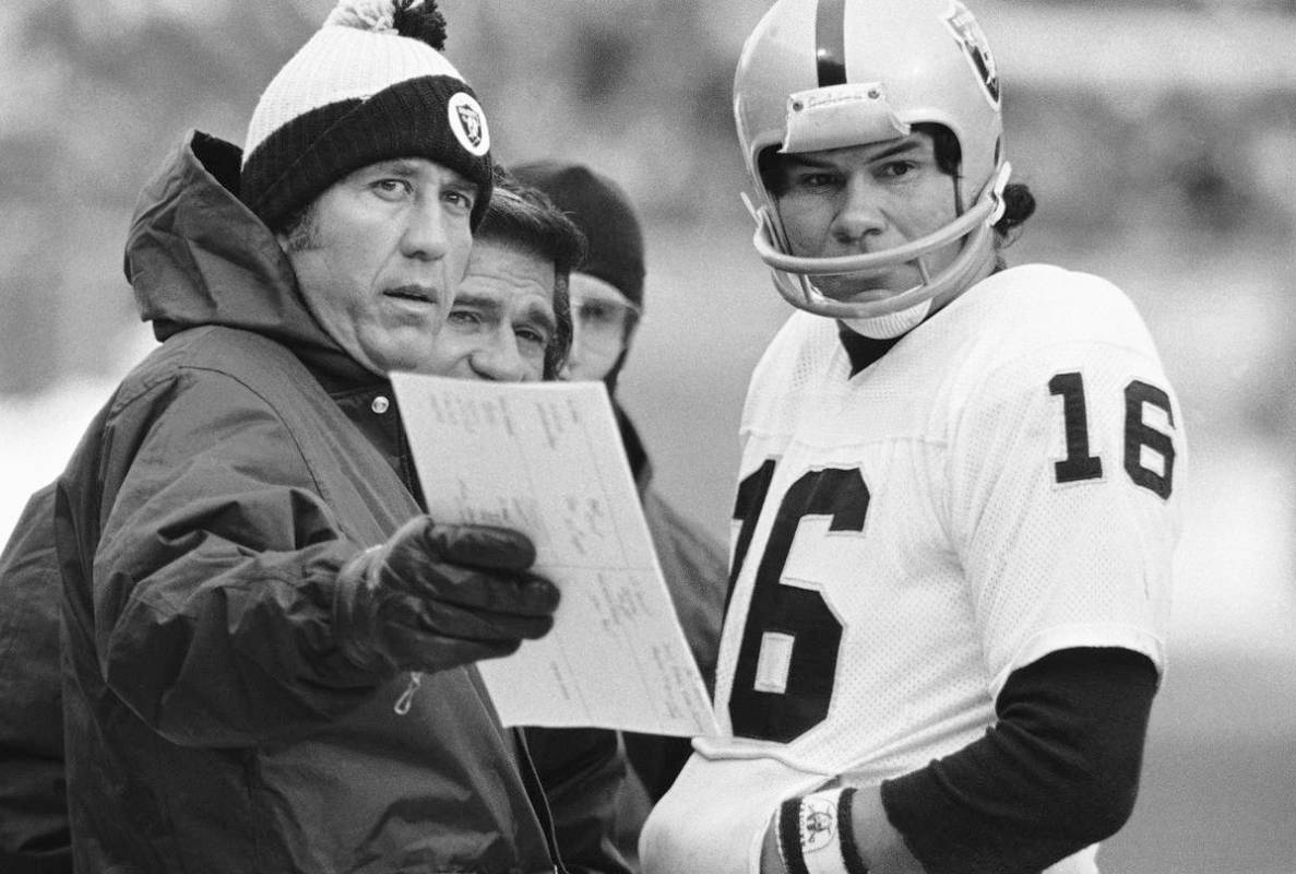 Oakland Raiders head coach Tom Flores talks over a play with quarterback Jim Plunkett during AF ...