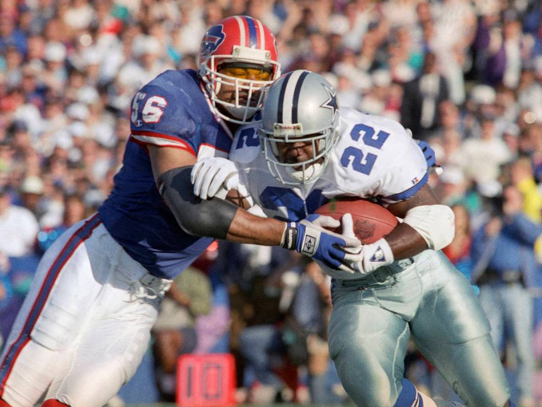 FILE - In this Jan. 31, 1993, file photo, Dallas Cowboys' Emmitt Smith (22) gains yardage on B ...