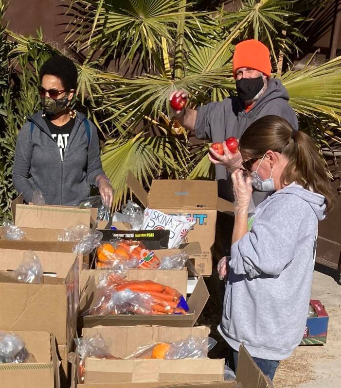 LasVegan Food Bank volunteers assemble grocery boxes on Jan. 23 at the nonprofit RIR Animal San ...