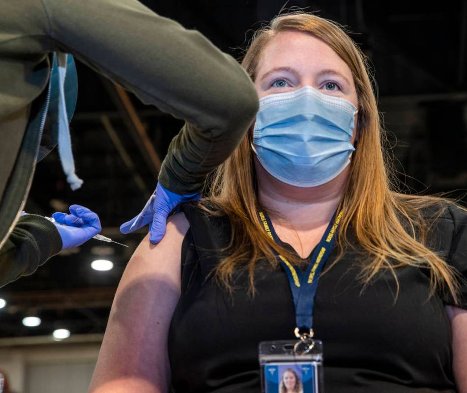 Jessica Johnson is injected with the Moderna vaccine at the Southern Nevada Health District's C ...