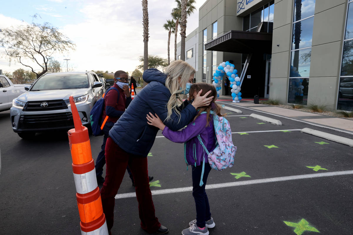 Kim Salerno kisses her daughter Tegan, 7, goodbye at the start of school at Coral Academy of Sc ...