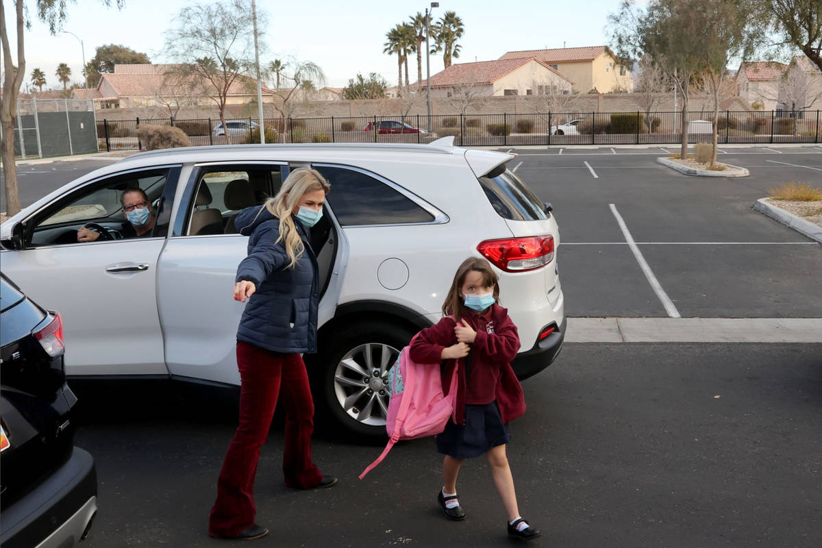 Kim Salerno directs Magdalena Vargas, 6, at the start of school at Coral Academy of Science Las ...