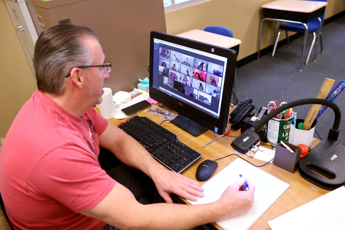 Roger Dunnavant teaches students remotely during school at Coral Academy of Science Las Vegas' ...