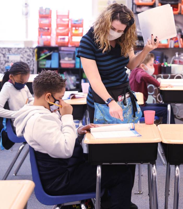 Teacher Michalle Santo Pietro works with Darrell Cosey, 10, during school at Coral Academy of S ...