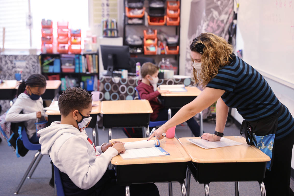 Teacher Michalle Santo Pietro works with Darrell Cosey, 10, during school at Coral Academy of S ...