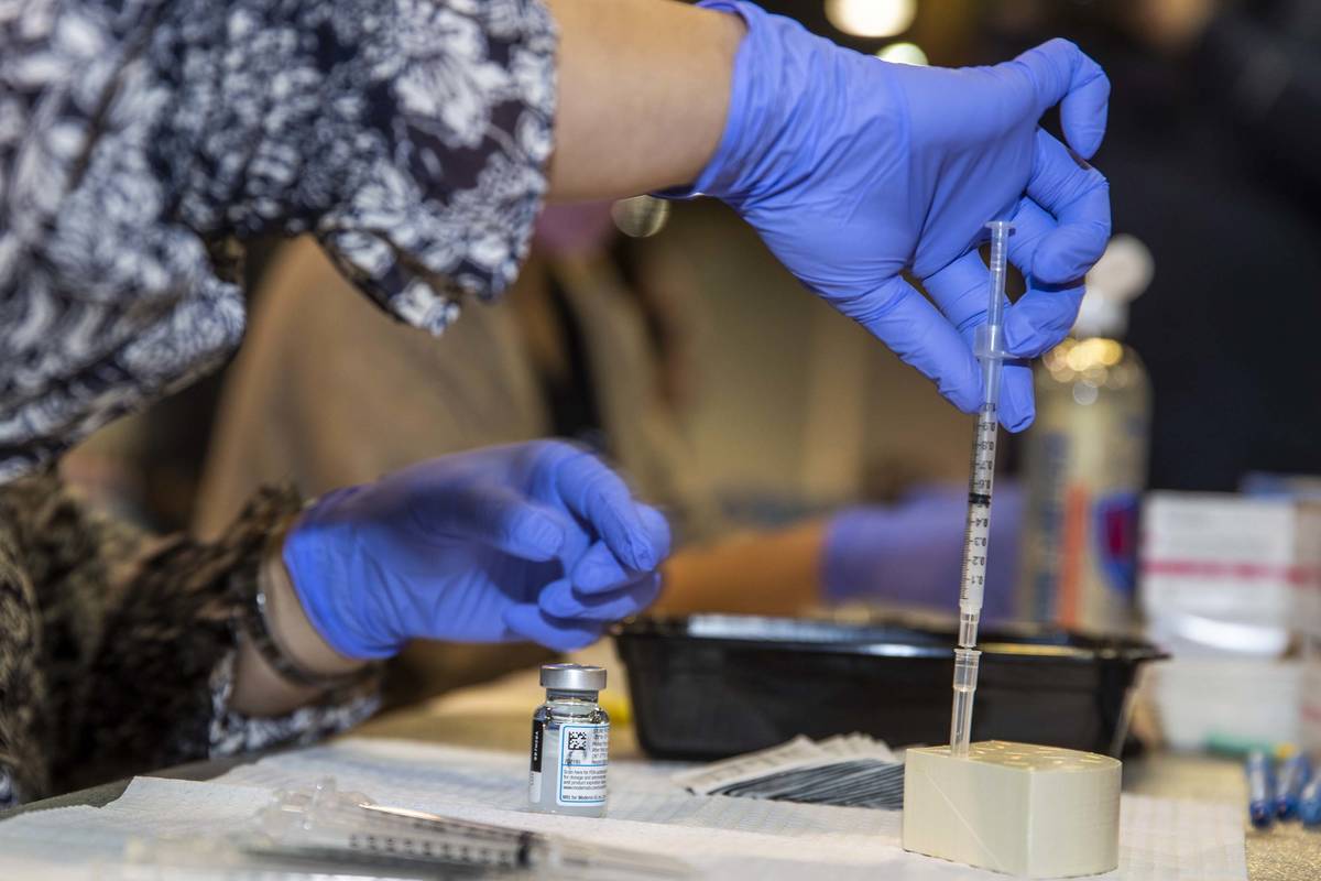 RN Dawn Schuder prepares another dose of the Moderna vaccine at the Southern Nevada Health Dist ...