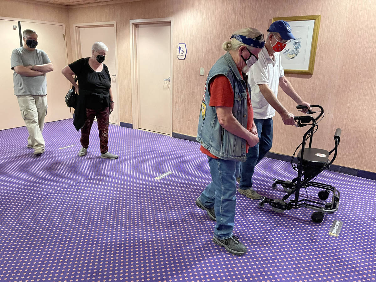 Terry Kutcher, 71, from right, Mike Smith, 71, Bonnie Moore, 71, and Terry Moore, 70, wait in l ...