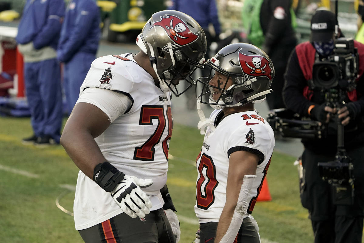 Tampa Bay Buccaneers' Scott Miller (10) celebrates his 39-yard touchdown reception with Tristan ...