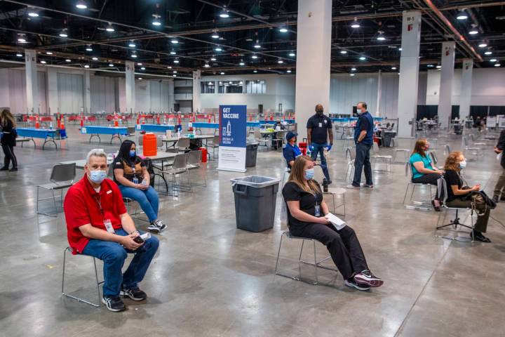 Staff members sit in the observation area after receiving the Moderna vaccine at the Southern N ...