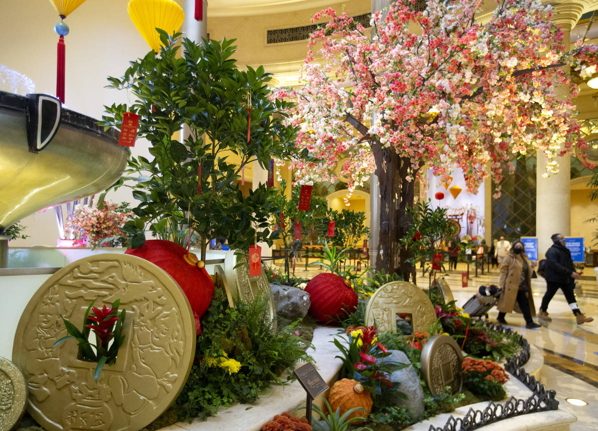 Visitors walk past a Wishing Tree art installation for the Lunar New Year at the Grand Canal Sh ...