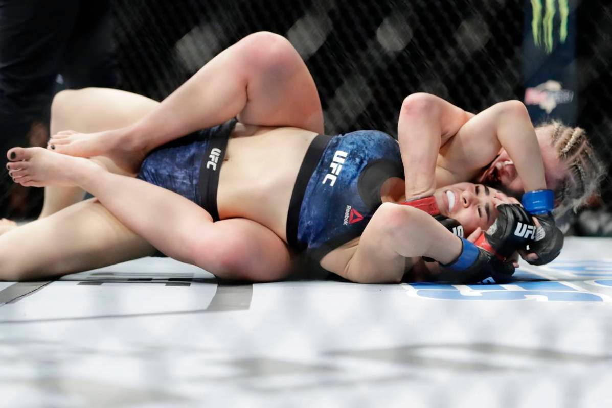 Paige Vanzant, right, wrestles with Rachael Ostovich during the second round of a women's flywe ...