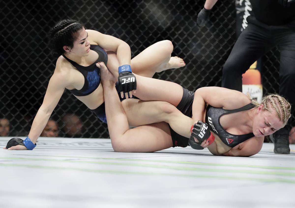 Rachael Ostovich, left, grapples with Paige Vanzant during the first round of a women's flyweig ...