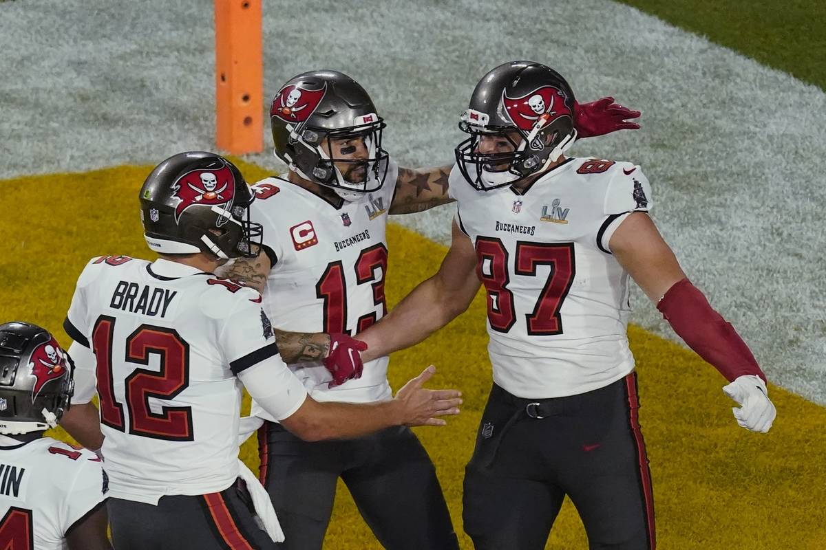 Tampa Bay Buccaneers quarterback Tom Brady (12) congratulates Rob Gronkowski (87) after scoring ...