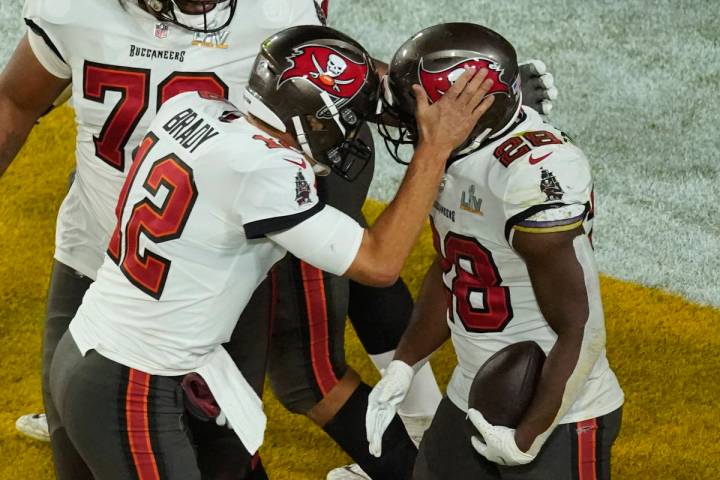 Tampa Bay Buccaneers' Leonard Fournette (28) celebrates his touchdown run with quarterback Tom ...