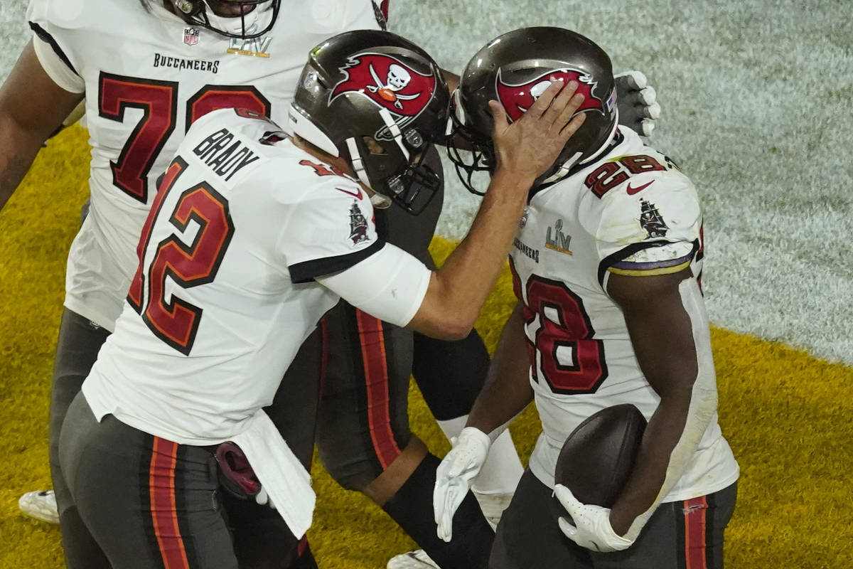 Tampa Bay Buccaneers' Leonard Fournette (28) celebrates his touchdown run with quarterback Tom ...