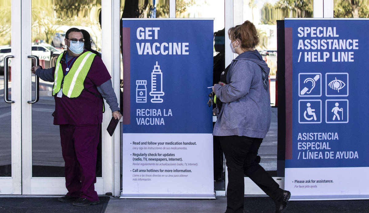 Sym Ciccone, left, a contact tracer from the Southern Nevada Health District, leads a woman int ...