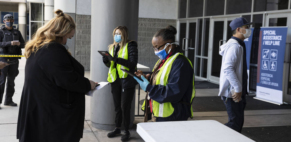 Volunteers from Federal Emergency Management Agency check in people who came to get their secon ...