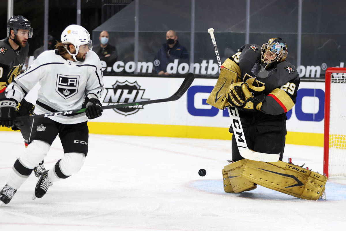 Vegas Golden Knights goaltender Marc-Andre Fleury (29) stops a shot as center Nicolas Roy (10) ...